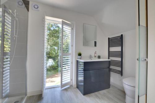 a bathroom with a sink and a toilet and a window at 1 Bed in Cranbrook oc-cb652 in Cranbrook
