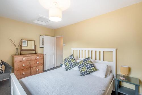 a bedroom with a bed with a dresser and a mirror at 1 Bed in Blakeney oc-674 in Blakeney