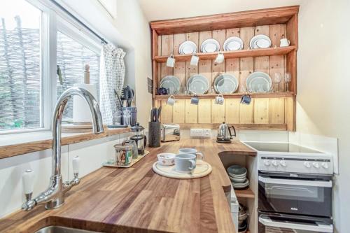 a kitchen with a sink and a counter with a plate on it at 1 Bed in Blakeney oc-674 in Blakeney