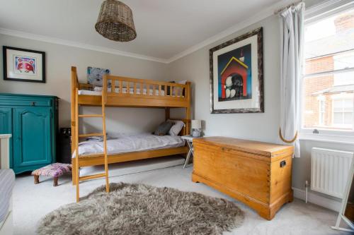 a bedroom with a bunk bed and a desk at 5 Bed in Southwold oc-tlw in Southwold