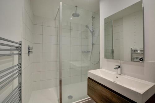 a white bathroom with a sink and a shower at 3 Bed in Cromer oc-1727 in Cromer