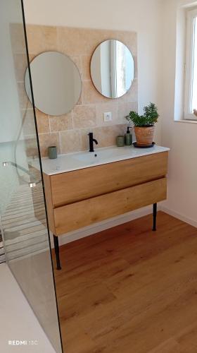 a bathroom with a sink and a mirror at le Cocon du Causse in Causse-de-la-Selle
