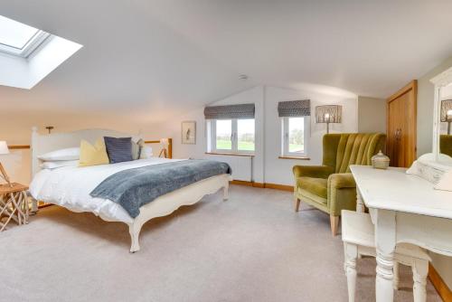 a bedroom with a bed and a green chair at 1 Bed in Beckley oc-rh1151 in Beckley