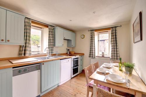 a kitchen with a table and a dining room at 2 Bed in Field Dalling oc-1643 in Saxlingham