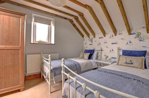 a bedroom with two twin beds and a window at 2 Bed in Field Dalling oc-1643 in Saxlingham