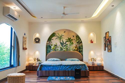 a bedroom with a bed with a mural on the wall at Zoe Cozy Escape with Big Projector in Amritsar