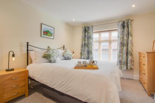 a bedroom with a large bed and a window at 3 Bed in Sheringham oc-2170 in Sheringham