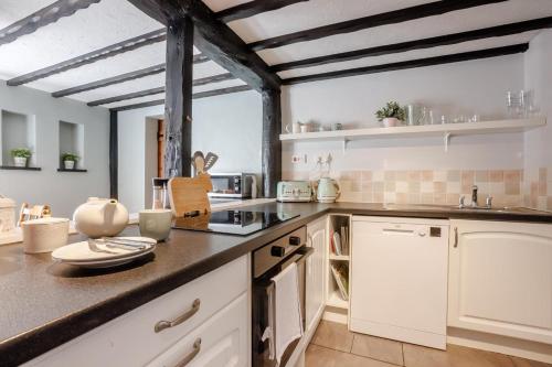 a kitchen with white cabinets and a counter top at 2 Bed in Swimbridge oc-n0209 in Swimbridge