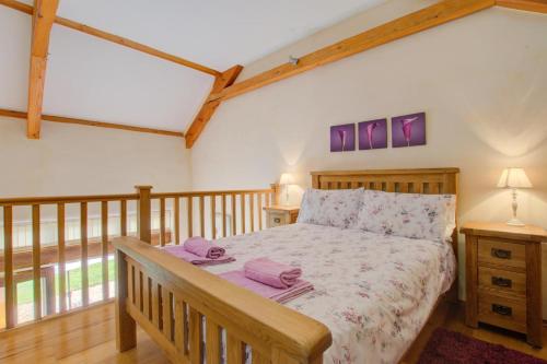 a bedroom with a bed with purple towels on it at 1 Bed in Tiverton oc-gear in Bampton