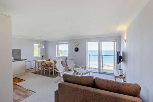a living room with a couch and a table with chairs at 2 Bed in Putsborough oc-f27451 in Croyde
