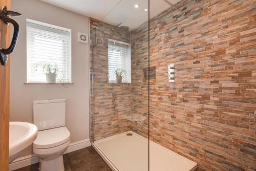 a bathroom with a toilet and a glass shower at 1 Bed in Saxtead oc-sfmhf in Saxtead