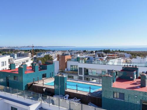 a view from the roof of a building with a swimming pool at Terracos Da Meia Praia in Meia Praia