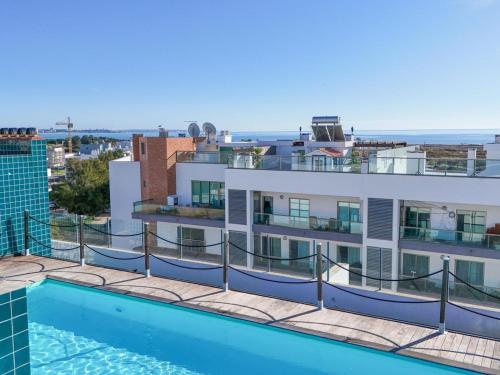 a swimming pool on the roof of a building at Terracos Da Meia Praia in Meia Praia