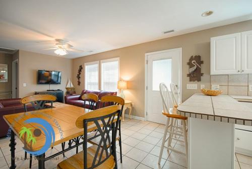 a kitchen and living room with a table and chairs at Sandcastle Up in Myrtle Beach