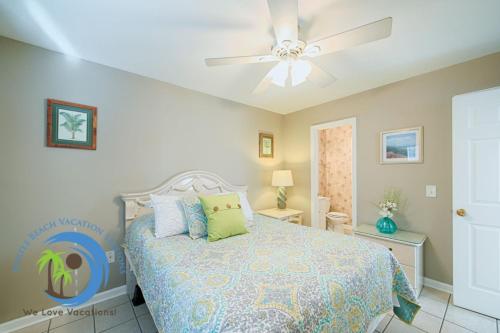 a bedroom with a bed and a ceiling fan at Sandcastle Up in Myrtle Beach