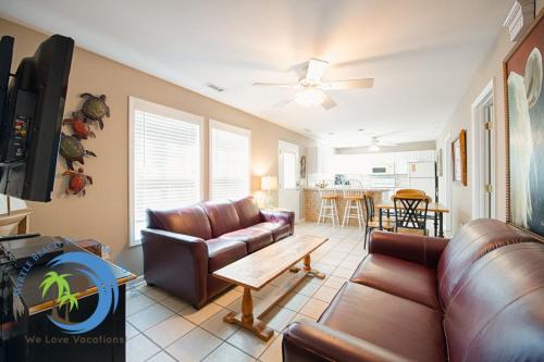 a living room with a couch and a table at Sandcastle Up in Myrtle Beach