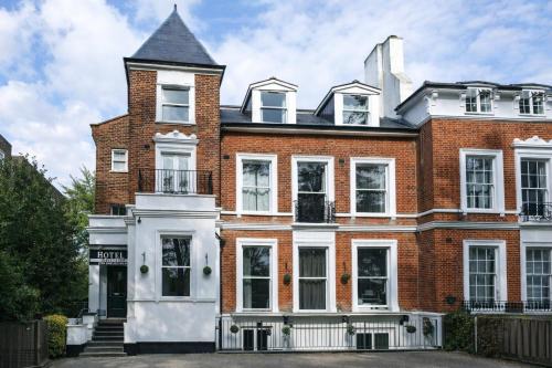 a large red brick house with a black roof at Beckenham Park Hotel in Beckenham