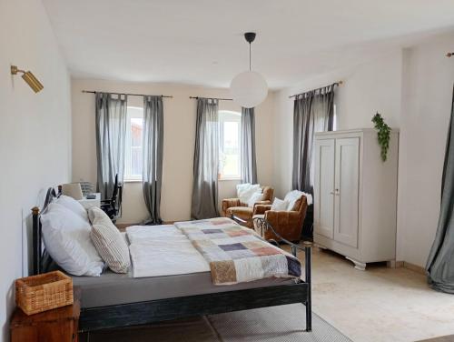 a bedroom with a bed and a living room at Cottage Living in Leiblfing