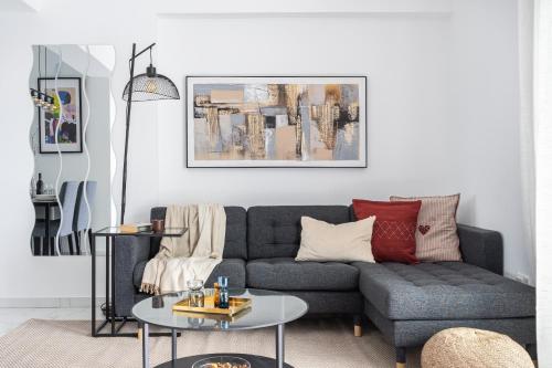 a living room with a couch and a table at Hinoki 2-Bedroom Apartment in Larnaca