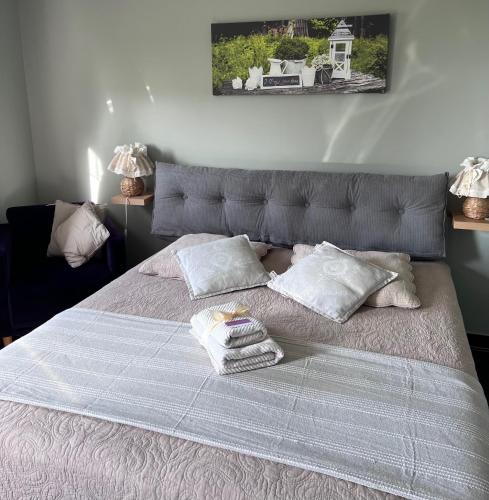 a large bed with two pillows on top of it at la ferme au bois dormant in Wemaers-Cappel