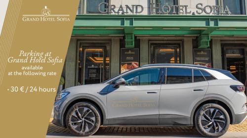 a white car parked in front of a building at Grand Hotel Sofia in Sofia