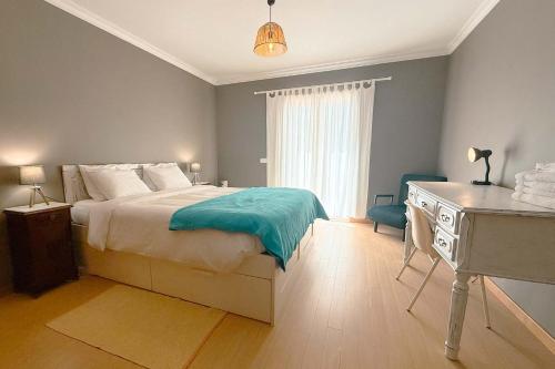 a bedroom with a bed and a desk and a bed sidx sidx sidx at Marta Apartment - Balcony, Patio, Pool in Ferrel