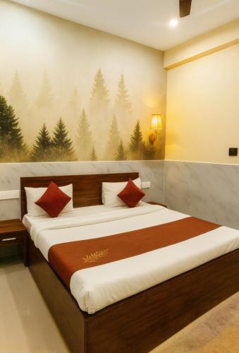 a bedroom with a bed with a painting on the wall at Hotel Royale Elite RK Residency in Vrindāvan