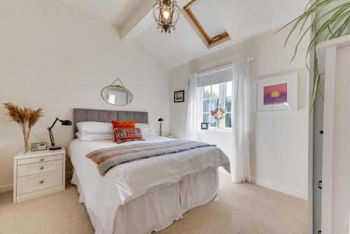 a bedroom with a large bed and a window at 1 Bed in Trimley St. Martin nr Felixstowe oc-obat in Trimley Heath