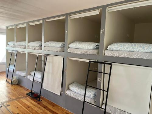 a room with four mattresses on shelves in a room at Daora Lisbon Beds in Lisbon
