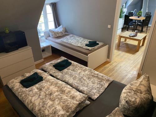a room with two beds in a room with a table at Flensburg Zentrum 69 03 in Flensburg