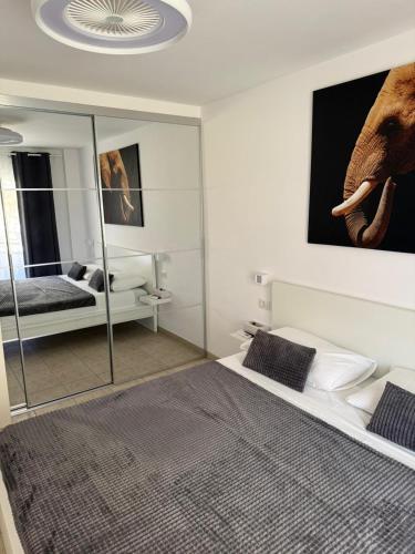a bedroom with an elephant picture on the wall at Casa de Rufio With Pool Tenerife in Puerto de Santiago