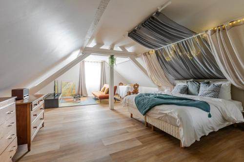 a bedroom with a canopy bed and a living room at Romantic 4-star suite with private heated pool in Gimbrett