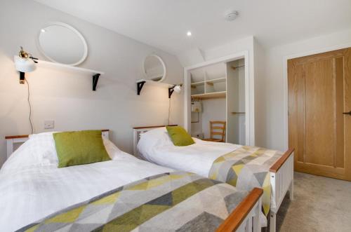 two beds in a bedroom with mirrors on the wall at 2 Bed in Edgefield oc-2140 in Edgefield