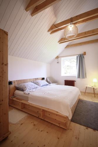 a bedroom with a large bed in a attic at Příchvoj 8 Český ráj in Sobotka