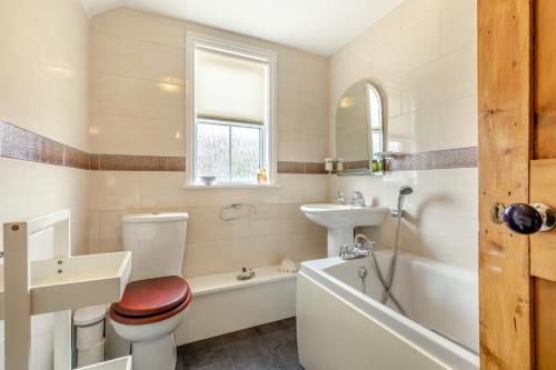 a bathroom with a sink and a toilet and a bath tub at 2 Bed in Mundesley oc-1353 in Mundesley