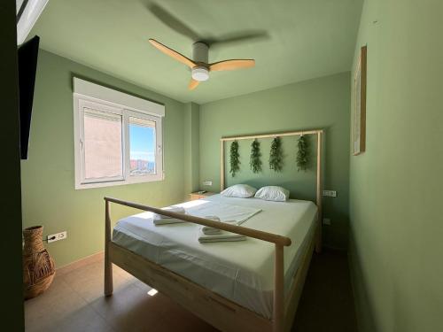 a bedroom with a bed with a ceiling fan at Veneziola Golf II by Alina365 in La Manga del Mar Menor