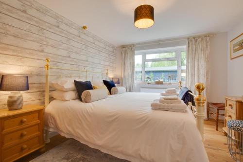 a bedroom with a large bed with white sheets and pillows at 2 Bed in Aldborough oc-2174 in Thurgarton