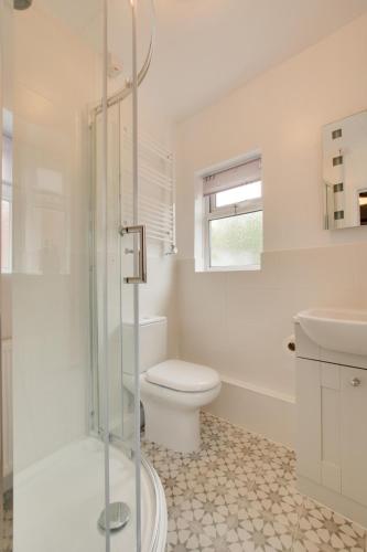 a white bathroom with a toilet and a shower at 2 Bed in Aldborough oc-2174 in Thurgarton