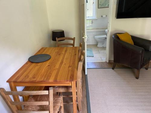 a living room with a wooden table and a couch at Bolthole in Hayle