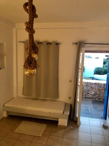a bathroom with a shower curtain and a window at Iosub Houses & Studios - Cosy Seaside House in Koumbara in Tzamaria