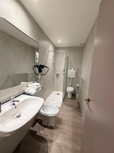 a bathroom with a sink and a toilet and a mirror at Confidence Hotel Europa in Cento