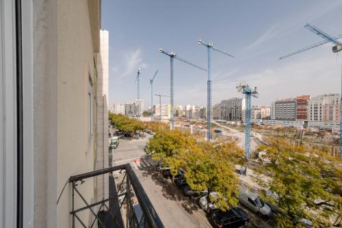 a view of a city from a balcony of a building at Soar Home l ENTRECAMPOS 3 l Central Comfort Stay, Fast WiFi, Steps to Metro, Near Campo Grande Park in Lisbon