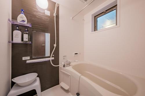 a bathroom with a tub and a toilet and a sink at Grace -Vacation stay-10min from Nagoya Free P 40m2 King Nomad in Nagoya
