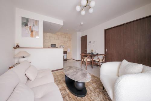 a living room with a white couch and a table at Grace -Vacation stay-10min from Nagoya Free P 40m2 King Nomad in Nagoya