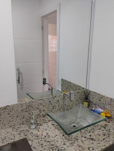 a bathroom counter with a sink and a mirror at Casa Tia Celinha e Cafeteria in Teresópolis