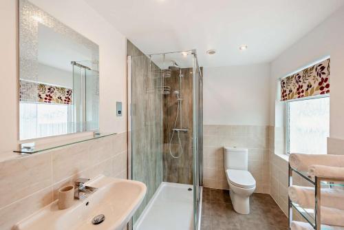 a bathroom with a shower and a sink and a toilet at 3 Bed in Woolacombe oc-clevel in Woolacombe