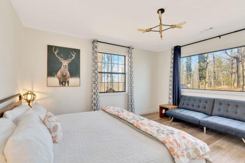 a bedroom with a bed and a blue couch at Lula Lake Cabin in Rising Fawn
