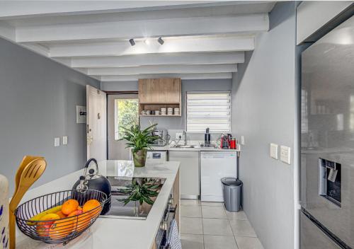 a kitchen with a bowl of oranges on a counter at Via Positano 95, Paulshof in Sandton