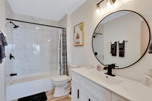 a white bathroom with a sink and a mirror at Lula Lake Cabin in Rising Fawn