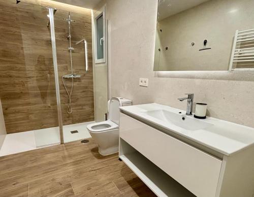 a bathroom with a sink and a toilet and a shower at Espacios Blanco Santiago in Valladolid